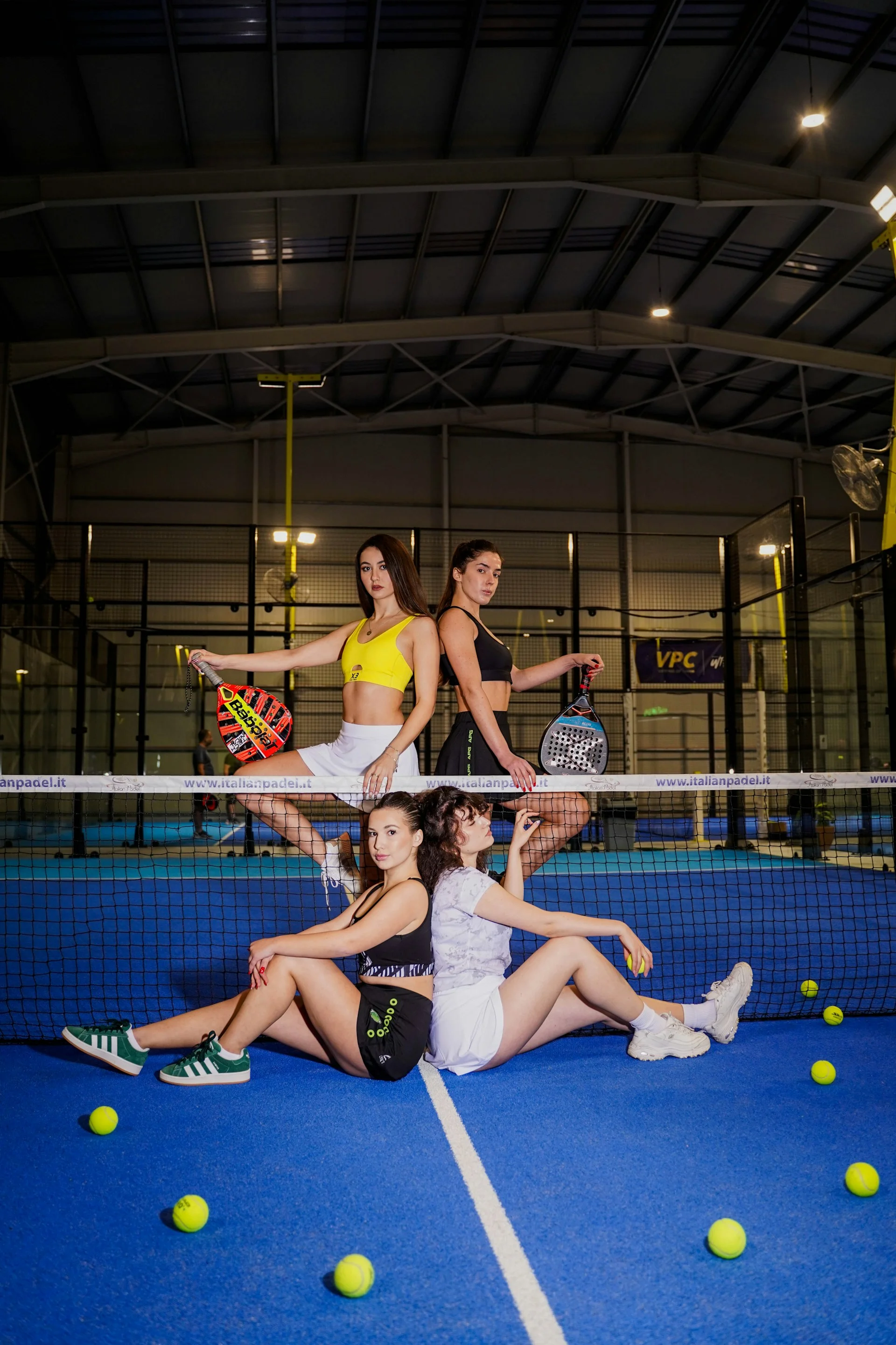 Group of padel players with rackets on court