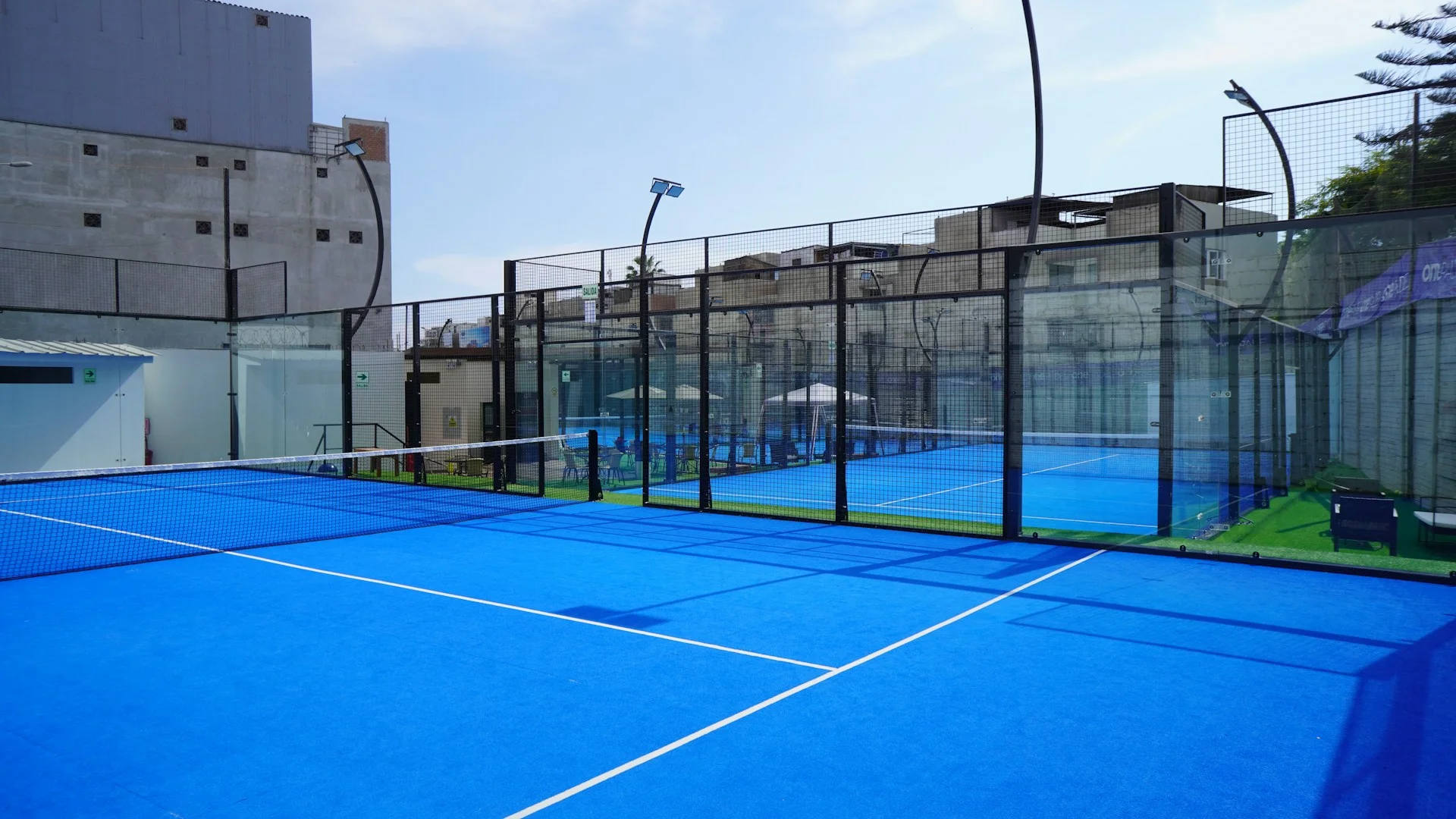 Padel court — glass walls with metallic fencing above